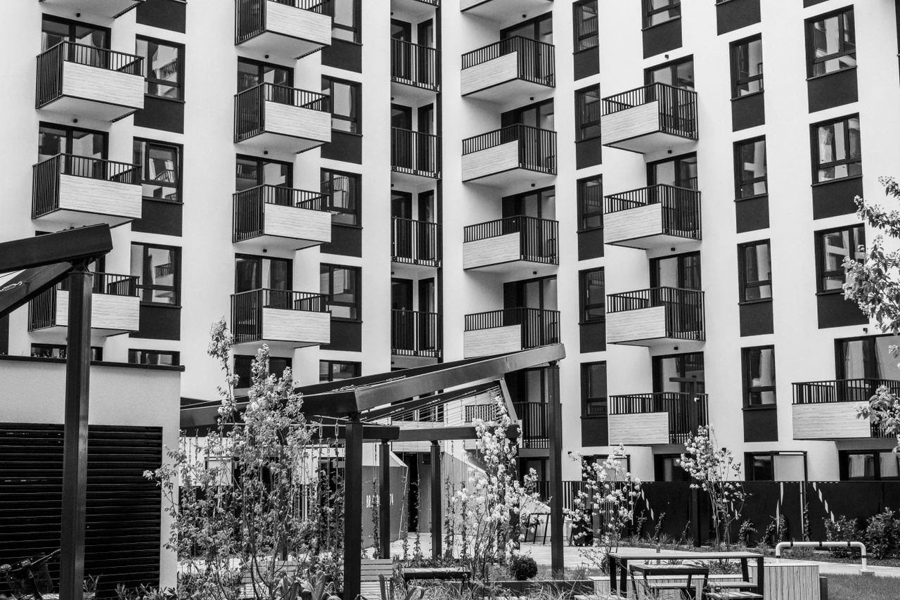Crafting Captivating Headlines: Your awesome post title goes here Contemporary urban apartment building with balconies and courtyard, black and white.